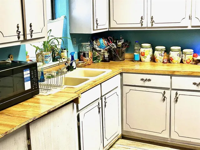 a bathroom with a sink mirror and toilet
