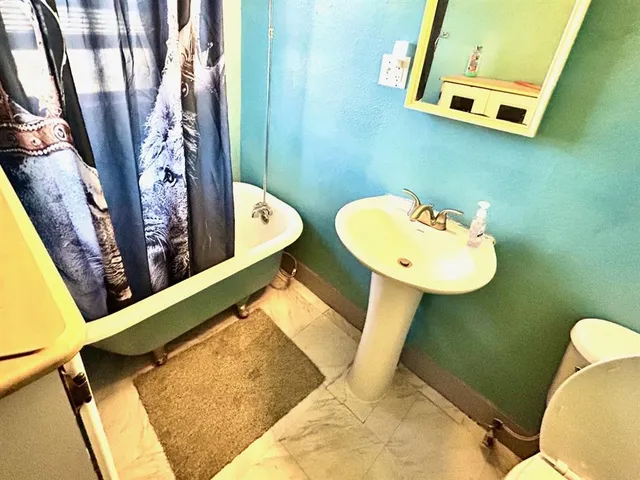 a bedroom that has a bed and a table in it