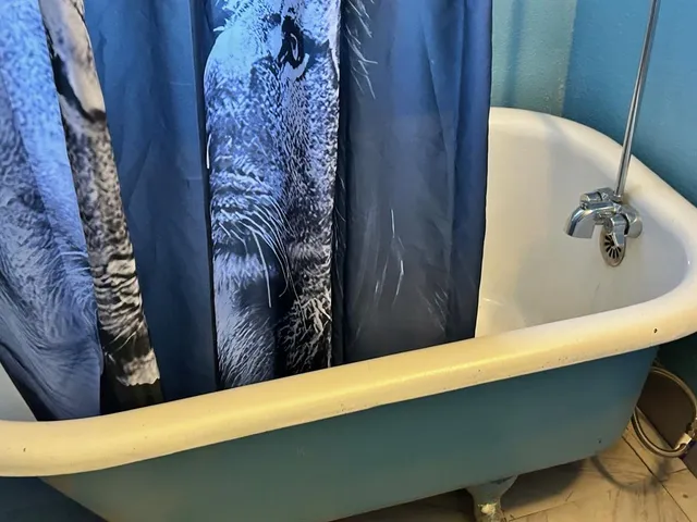 a bedroom with a bed and a mirror