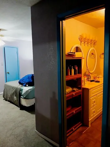 a bedroom with a bed and a lamp