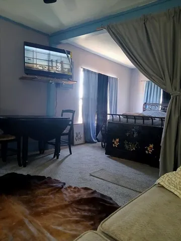 a view of large house with a yard covered with snow in front of house