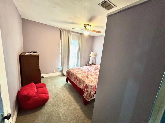 a view of a balcony with wooden floor and door