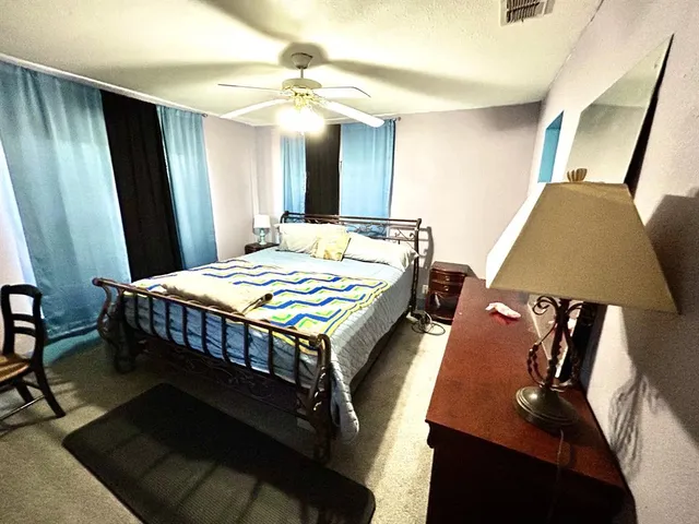 a view of a house with backyard and trees