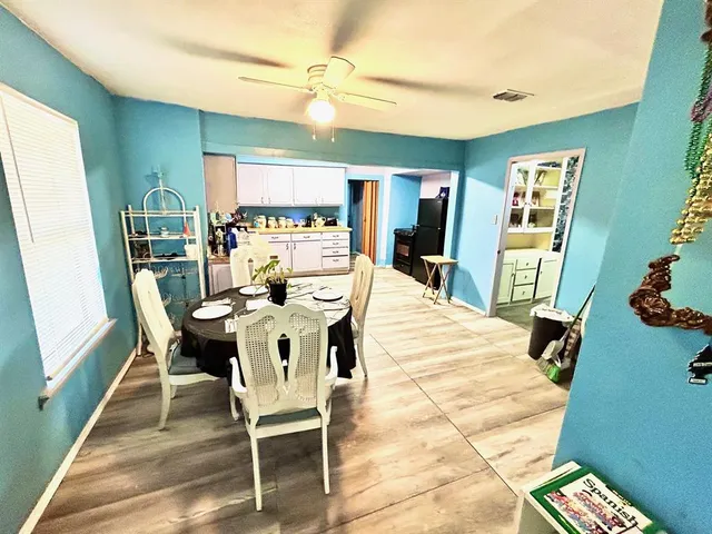 a living room with furniture and a air conditioner vent