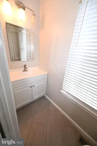 a bathroom with a sink a mirror and a bathtub