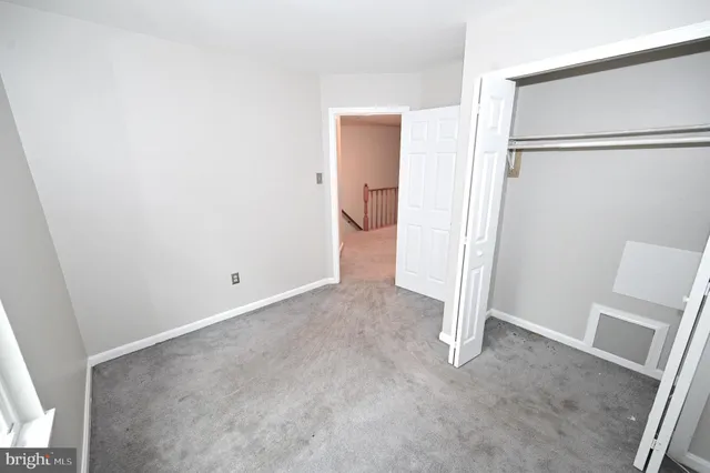 a bathroom with a granite countertop sink a toilet and a shower