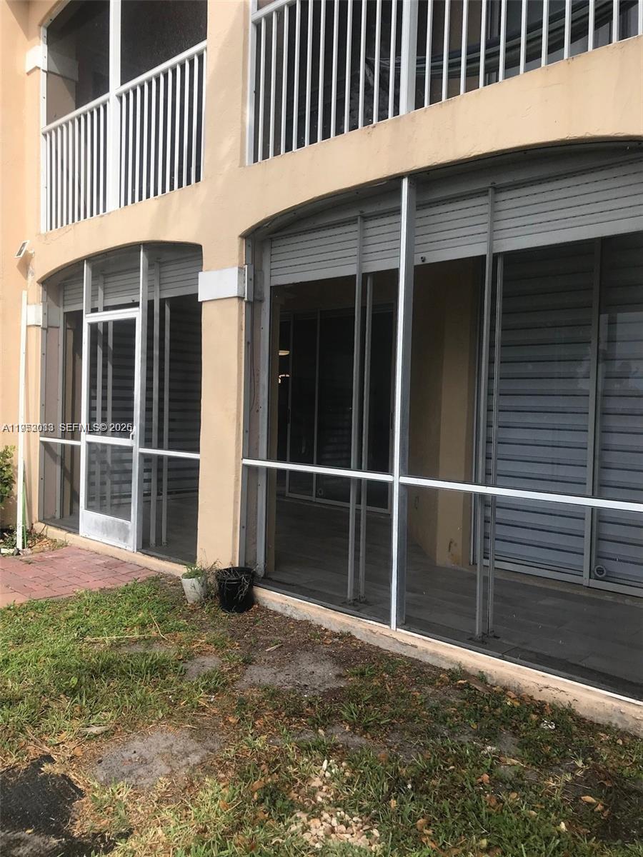 14621 Balgowan Road, Unit 1023 Miami Lakes, FL 33016 - Photo 14 of 21 a porch with a yard