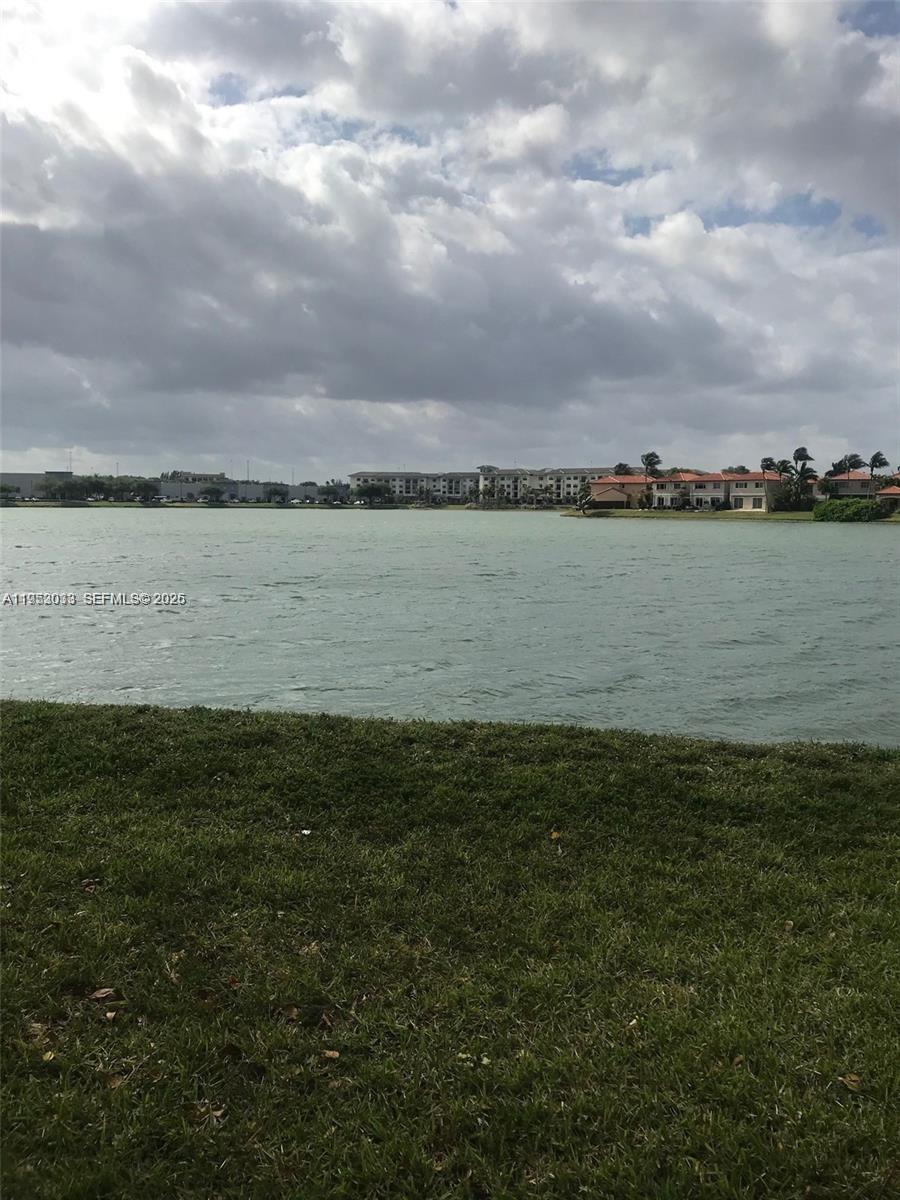 14621 Balgowan Road, Unit 1023 Miami Lakes, FL 33016 - Photo 15 of 21 a view of a lake from a yard