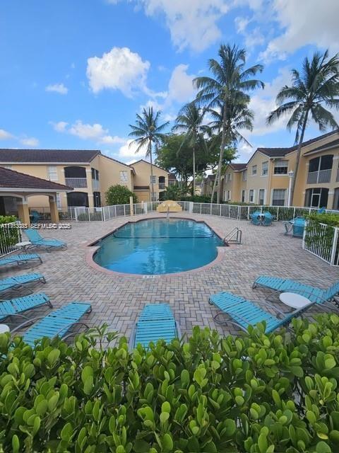 14621 Balgowan Road, Unit 1023 Miami Lakes, FL 33016 - Photo 16 of 21 a view of a house with a swimming pool
