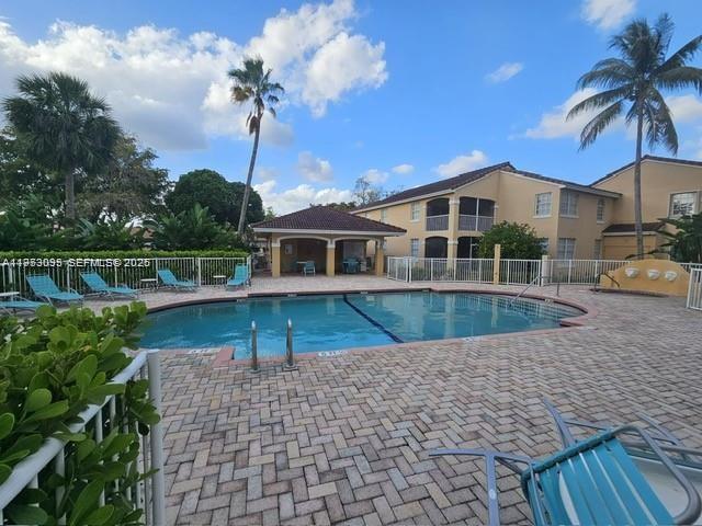 14621 Balgowan Road, Unit 1023 Miami Lakes, FL 33016 - Photo 17 of 21 a front view of a house with a yard