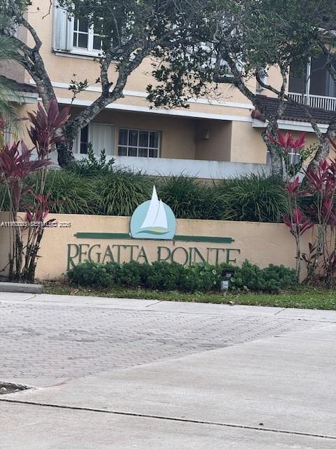 14621 Balgowan Road, Unit 1023 Miami Lakes, FL 33016 - Photo 20 of 21 a front view of house with yard and trees