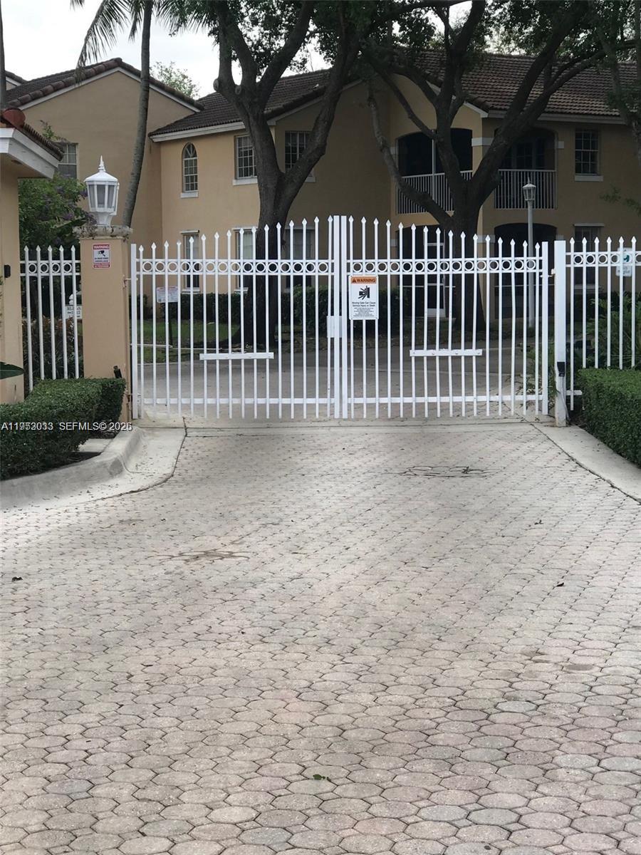 14621 Balgowan Road, Unit 1023 Miami Lakes, FL 33016 - Photo 2 of 21 a front view of a house with a garden