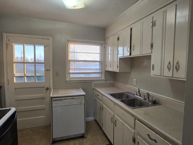 a kitchen that has a sink and a stove