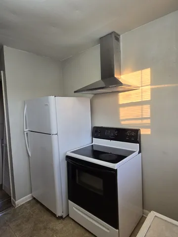 a kitchen with a stove and a refrigerator