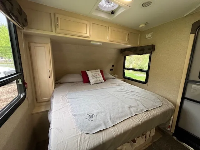 a bedroom with a bed and wooden floor