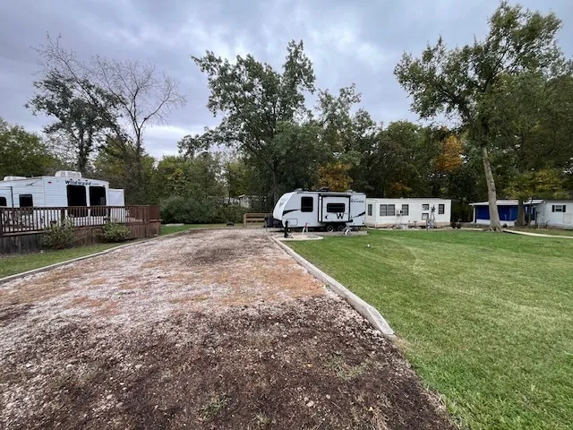 a view of a house with a yard and sitting area