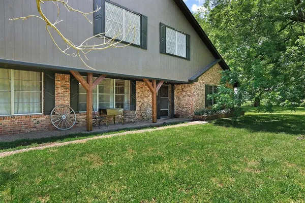 a front view of a house with swimming pool having outdoor seating