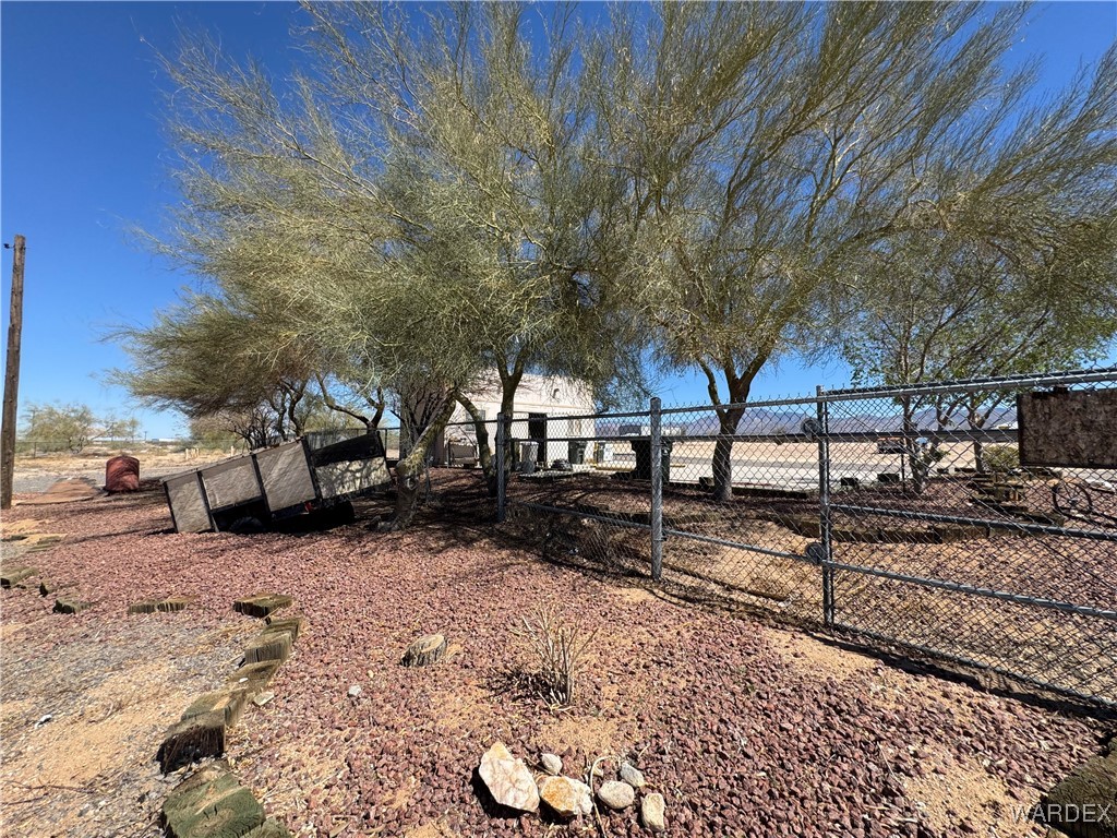 12248 South Yucca Frontage Road Yucca, AZ 86438 - Photo 4 of 16 a view of a yard with a tree