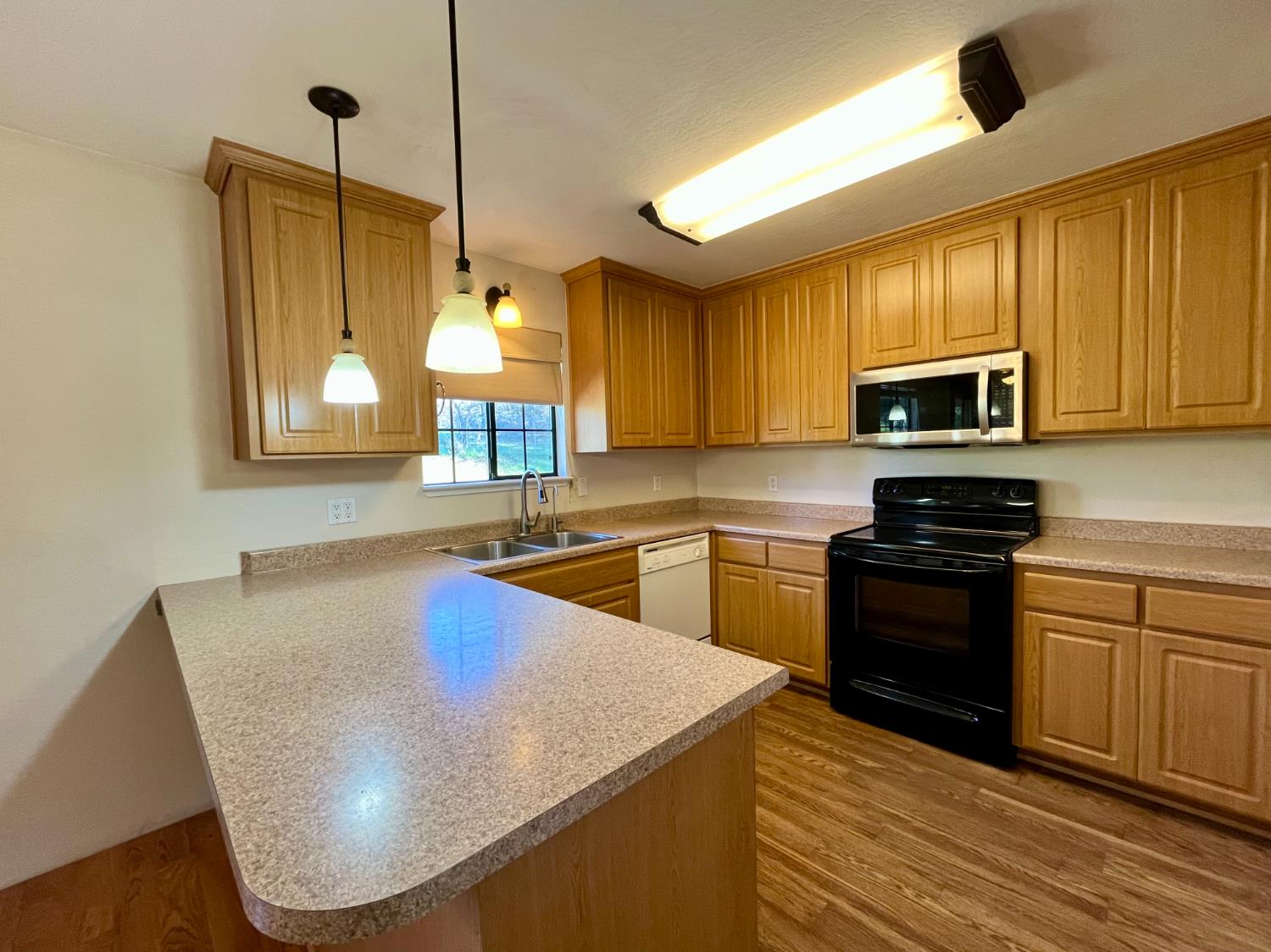10747 Mt Vernon Road Auburn, CA 95603 - Photo 11 of 33 a kitchen with stainless steel appliances granite countertop a stove a sink and a microwave