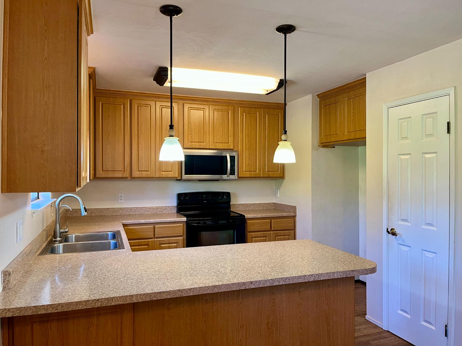 10747 Mt Vernon Road Auburn, CA 95603 - Photo 12 of 33 a kitchen with kitchen island a sink appliances and cabinets