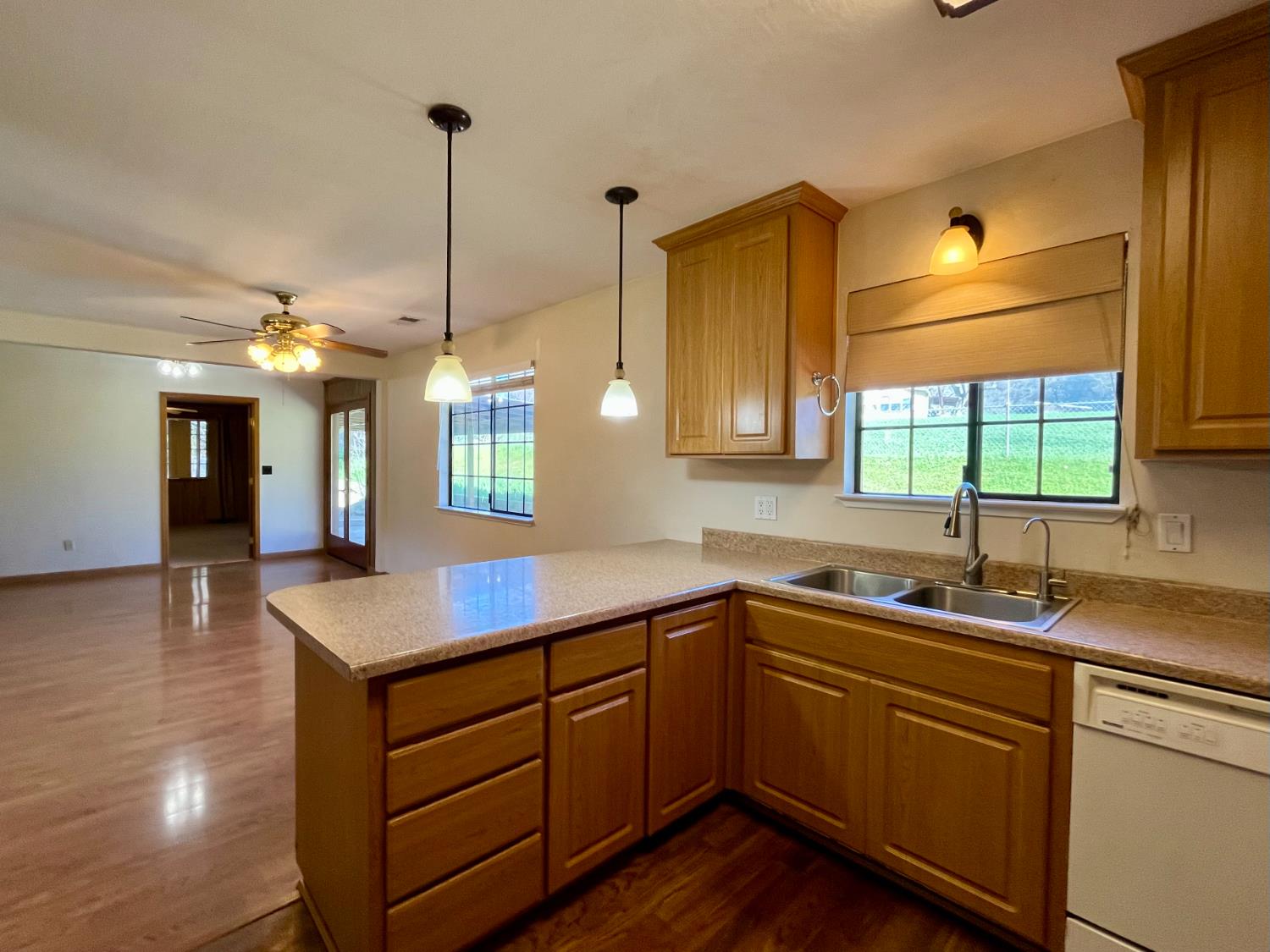 10747 Mt Vernon Road Auburn, CA 95603 - Photo 14 of 33 a kitchen with a sink dishwasher and cabinets with wooden floor