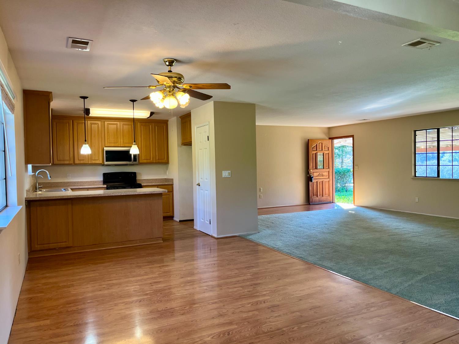 10747 Mt Vernon Road Auburn, CA 95603 - Photo 15 of 33 a kitchen with stainless steel appliances granite countertop a refrigerator a stove a sink dishwasher and a refrigerator with wooden floor
