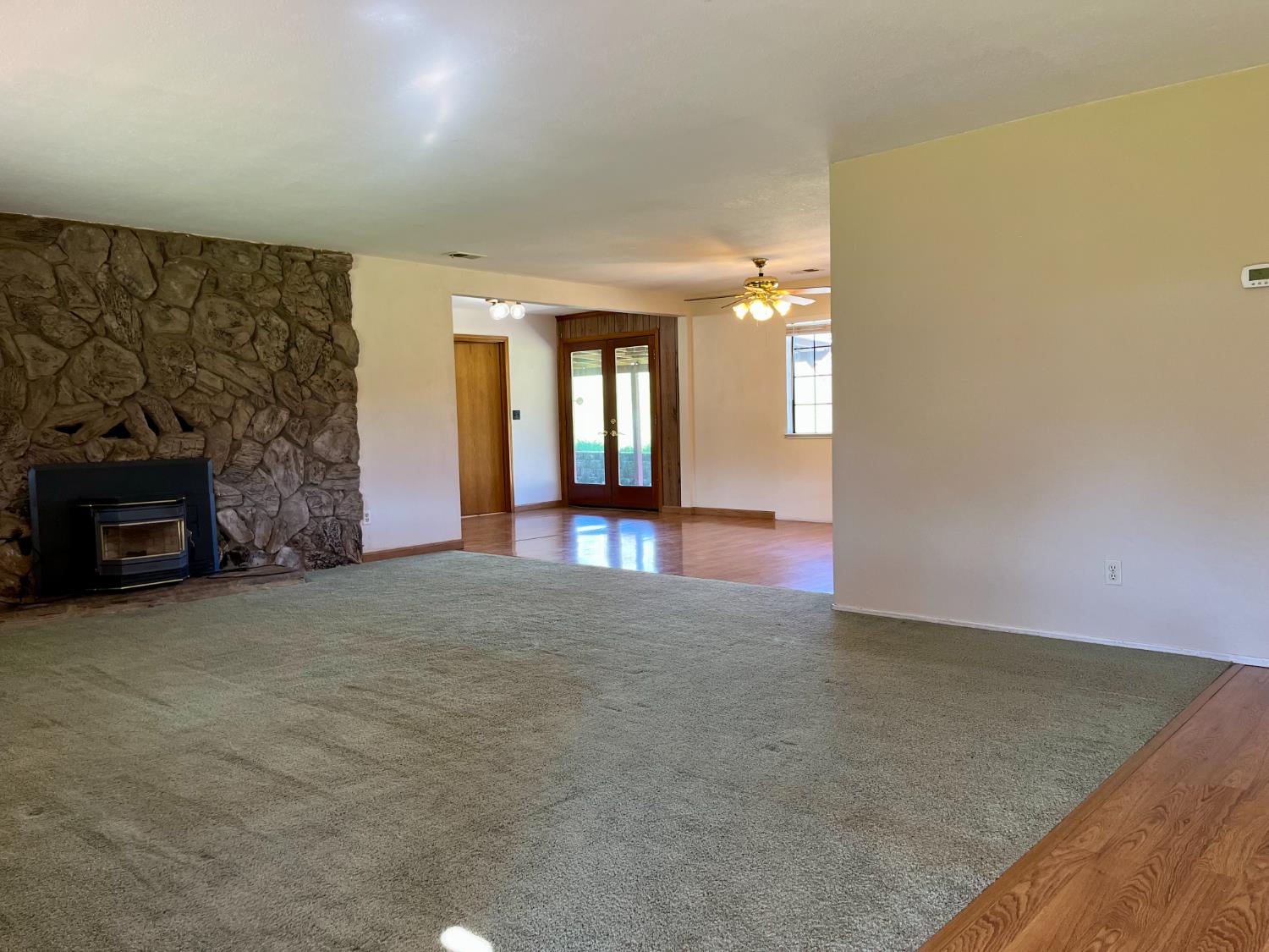 10747 Mt Vernon Road Auburn, CA 95603 - Photo 9 of 33 an empty room with windows and fireplace