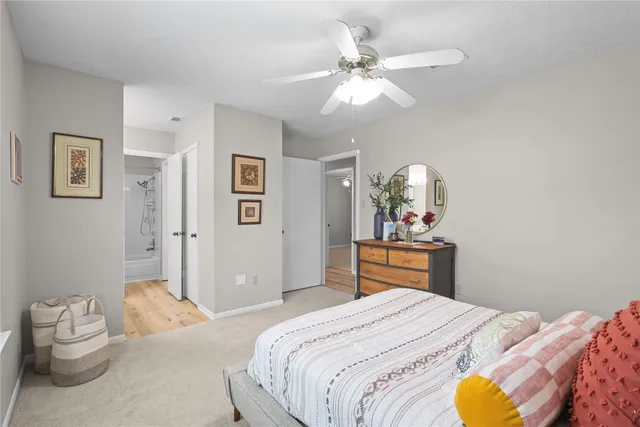 a bedroom with a large bed and a chandelier