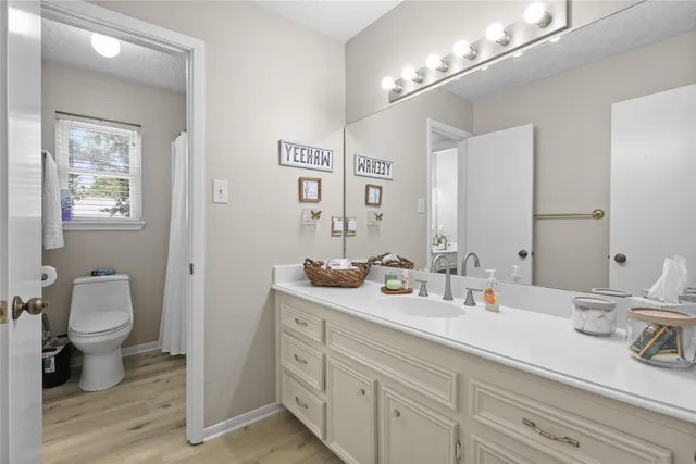 a bathroom with a double vanity sink and a mirror