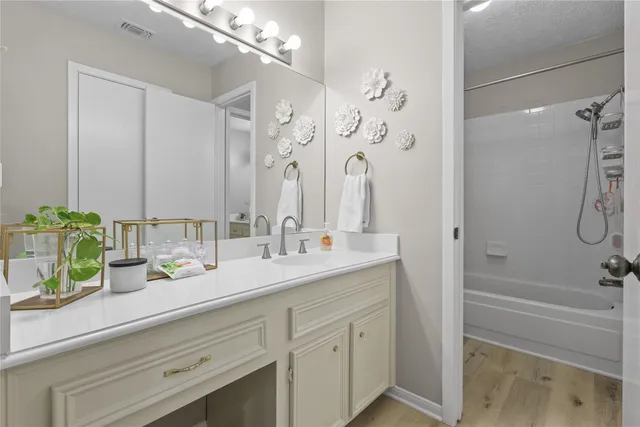 a bathroom with a double vanity sink mirror and shower