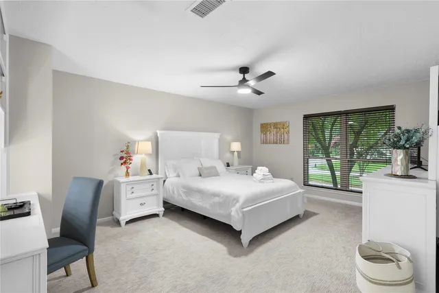 a bedroom with a bed and a chair