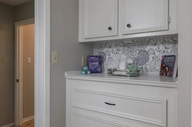 a kitchen with white cabinets and a sink
