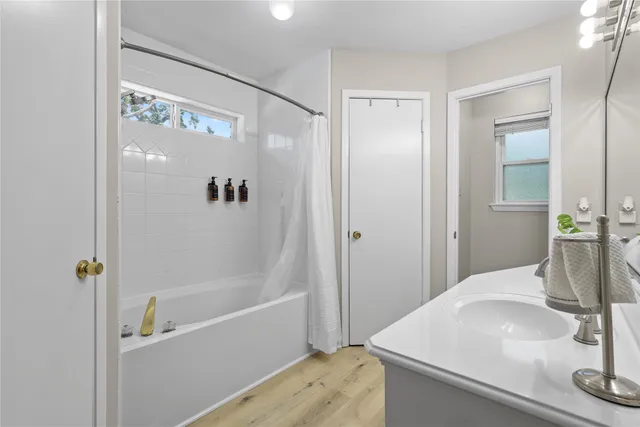 a bathroom with a bathtub and a shower