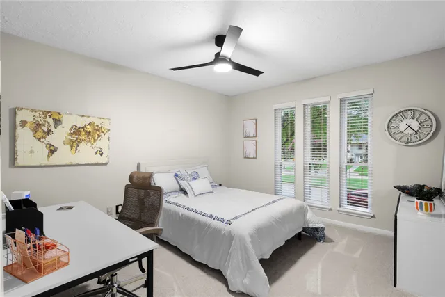 a bedroom with a bed and glass window