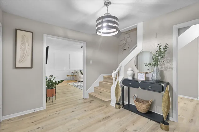a view of entryway and hall with wooden floor