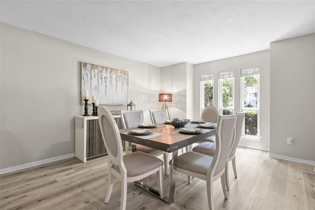a view of a dining room with furniture and wooden floor