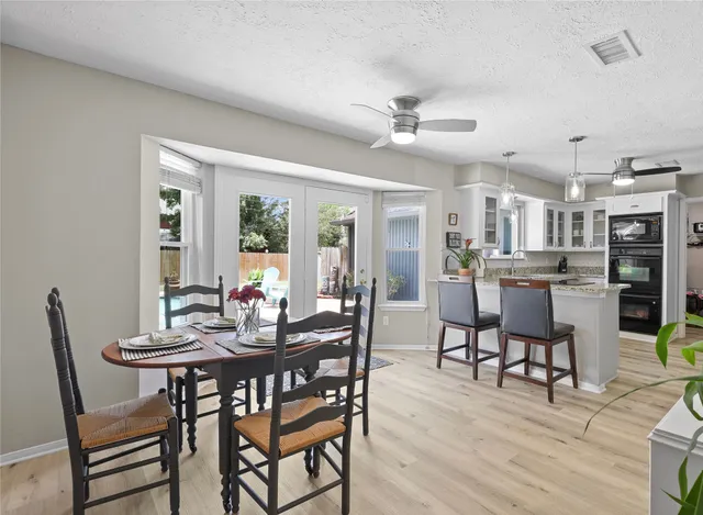 a view of a dining room with furniture and wooden floor