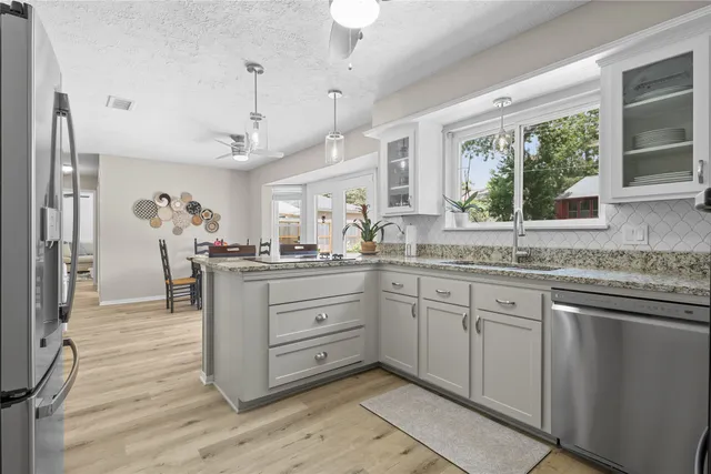 a kitchen with a sink cabinets and window