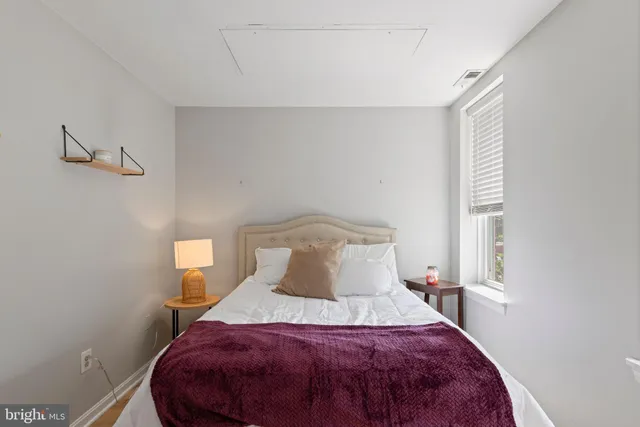 a bedroom with a bed and a window