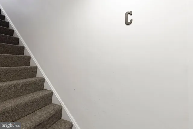 a view of staircase with white walls