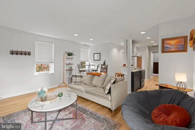 a living room with furniture and a wooden floor