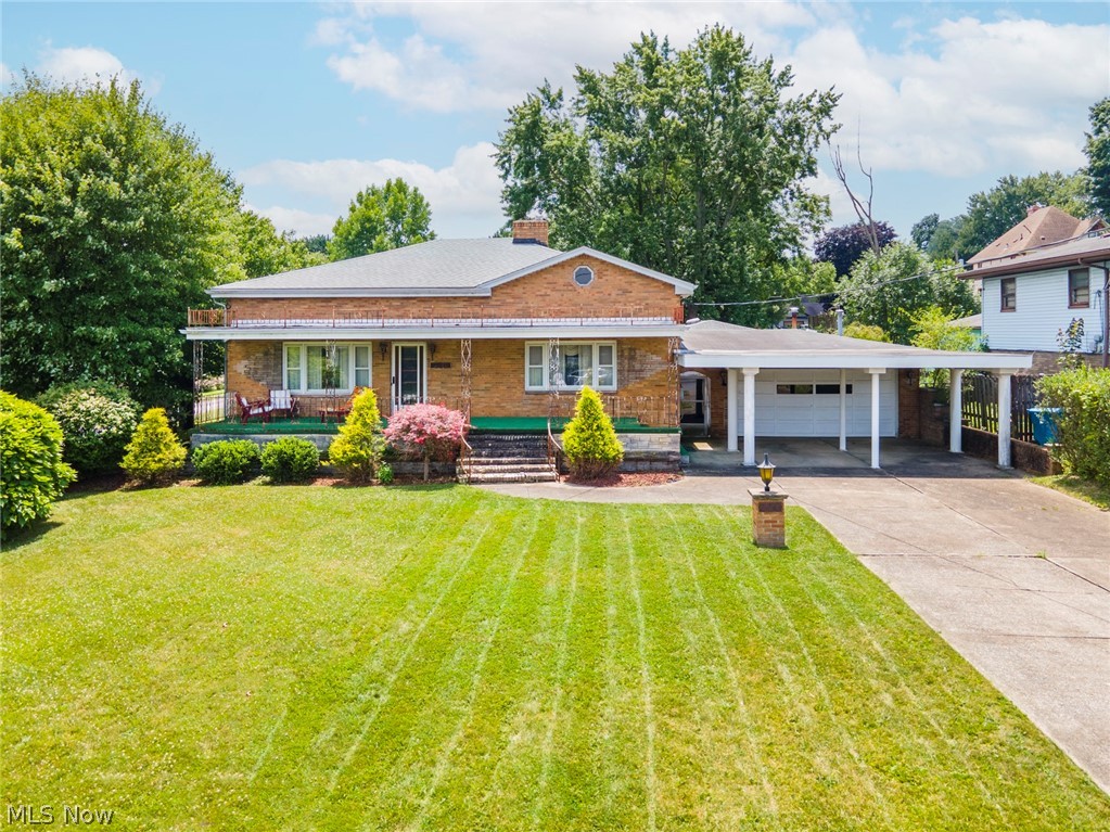550 Edison Street Struthers, OH 44471 - Photo 1 of 23 View of front of property with a garage, a front lawn, a carport, and covered porch