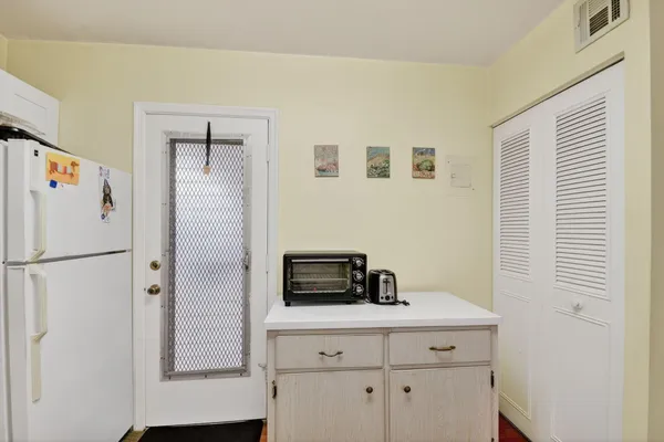 a white refrigerator freezer sitting in a kitchen