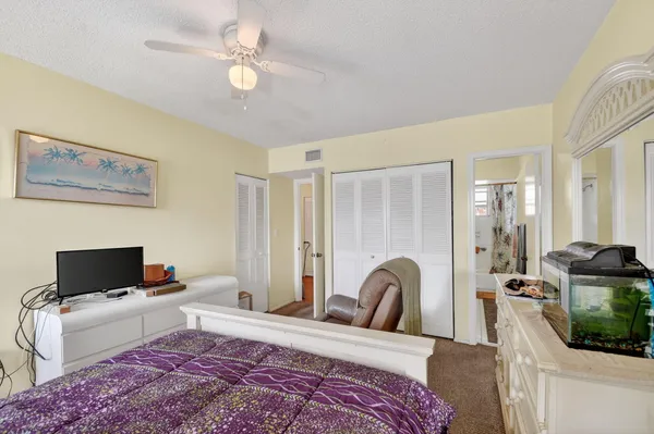 a bedroom with a bed and a television