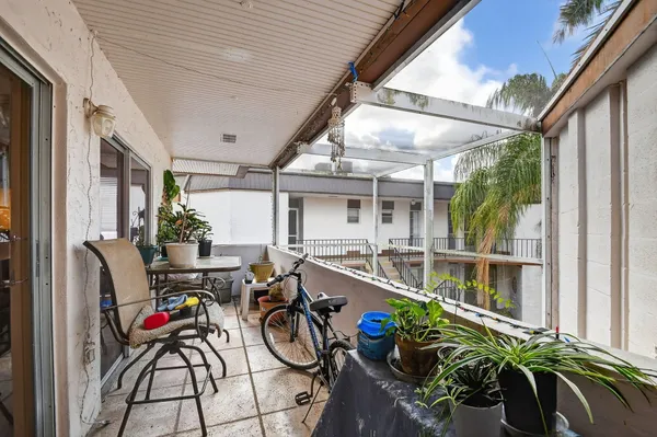 a view of a balcony with furniture