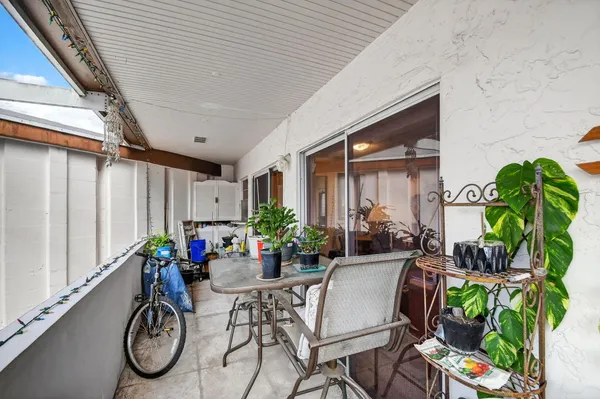a view of an chairs and table in a patio