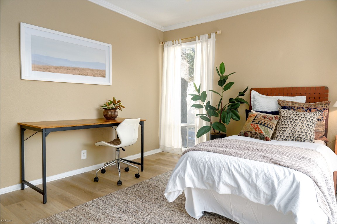 5326 Balcones Drive, Unit D Austin, TX 78731 - Photo 13 of 28 a bedroom with a bed and a potted plant