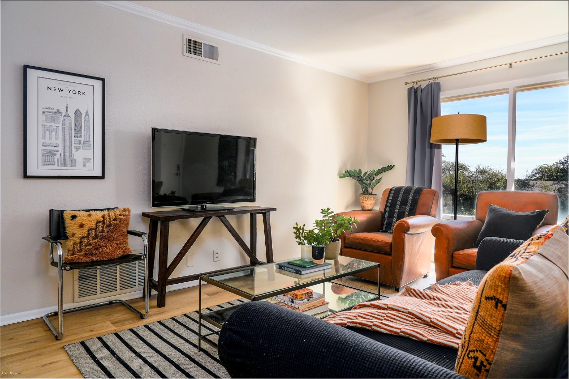 5326 Balcones Drive, Unit D Austin, TX 78731 - Photo 2 of 28 a living room with furniture a flat screen tv and a lamp