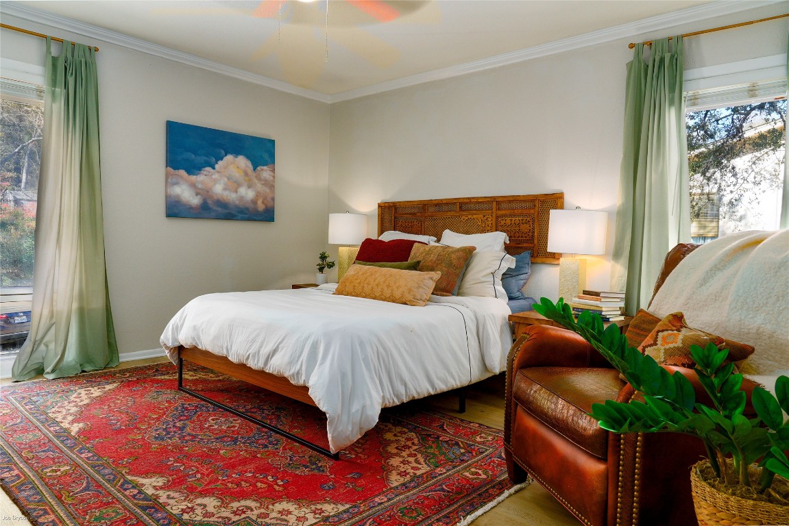 5326 Balcones Drive, Unit D Austin, TX 78731 - Photo 10 of 28 a bedroom with a bed and a painting on the wall