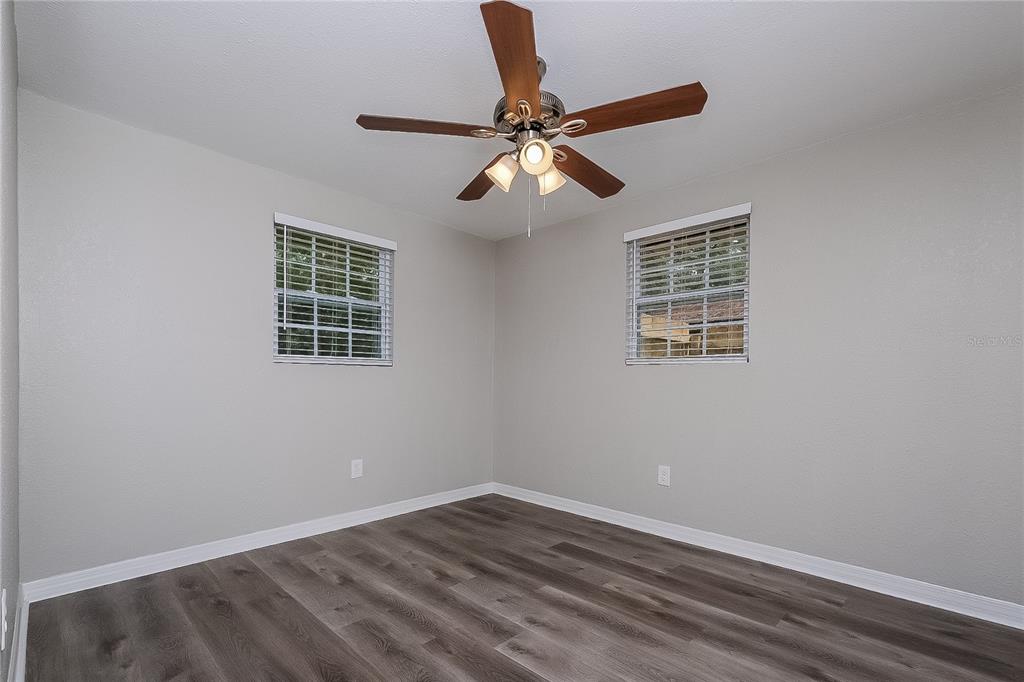 7145 Pinewood Drive New Port Richey, FL 34652 - Photo 11 of 16 a view of an empty room with wooden floor and a window